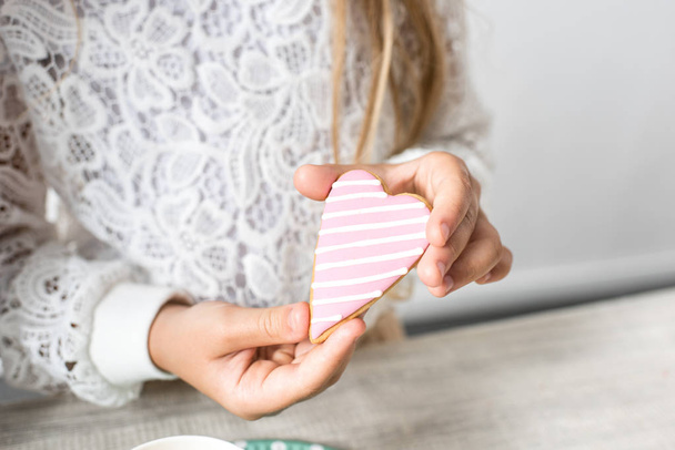 girl holding heart shaped cookie - Фото, изображение