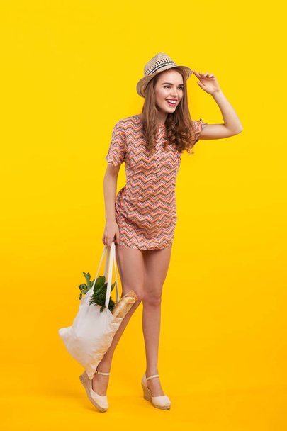 Cheerful woman with bag of products - Fotoğraf, Görsel