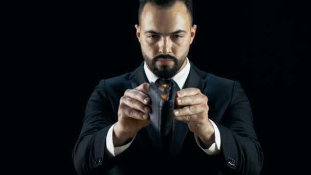 Professional Magician in a Dark Suit Performs Burning Wallet Trick. Bankruptcy Themed Illusion.  - Séquence, vidéo