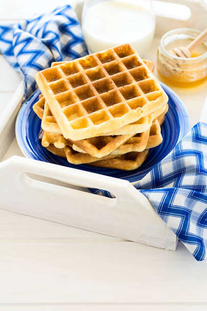 Healthy breakfast: Belgian waffles with blackberries, honey and milk decorated mint leaves and blue napkin  - Φωτογραφία, εικόνα