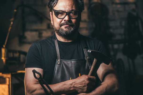 Cool blacksmith portrait with beard in workshop - Photo, Image