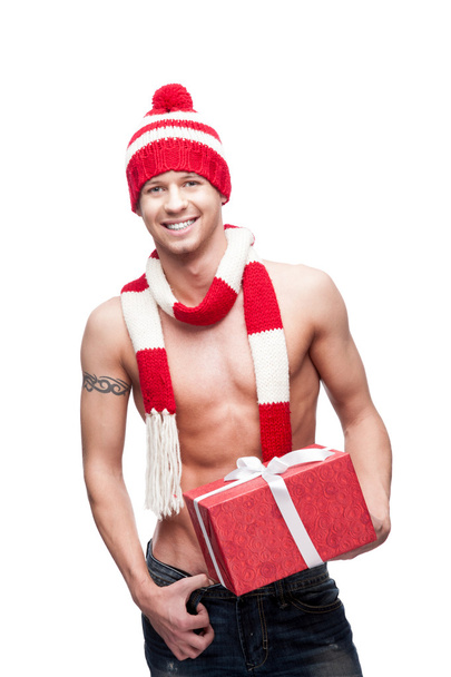 Sexy macho holding red gift - Foto, afbeelding