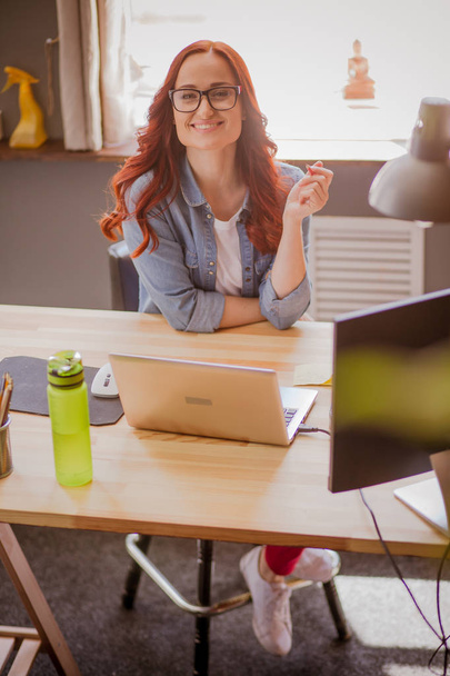 Ginger haired freelancer female working from home. - Photo, image