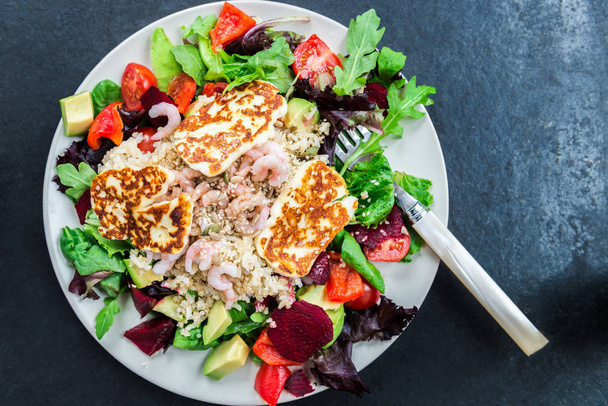 Warm Salad from Brown Rice, Quinoa, Prawns, Halloumi and Veg - Photo, Image