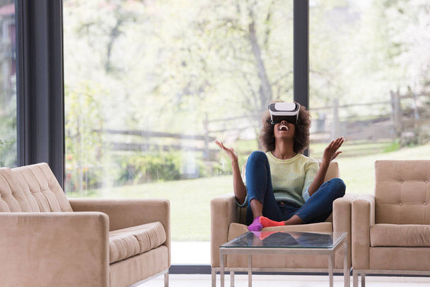 black woman using VR headset glasses of virtual reality - Фото, зображення