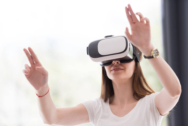 woman using VR-headset glasses of virtual reality - Фото, изображение
