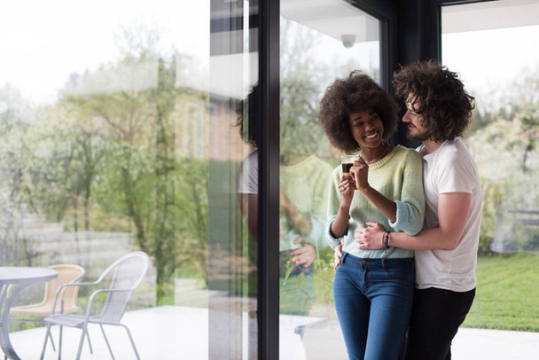 happy multiethnic couple relaxing at modern home indoors - Fotoğraf, Görsel
