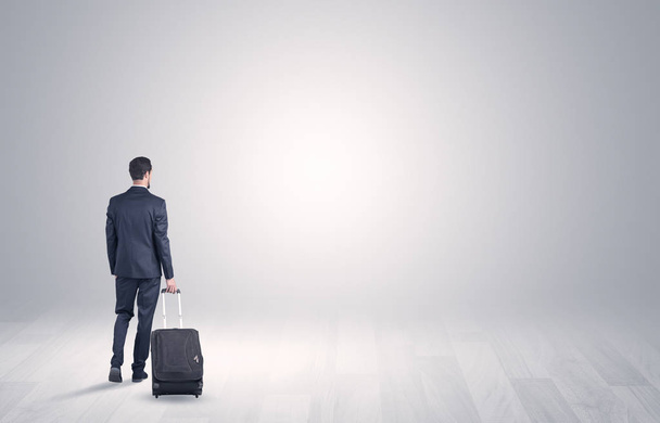 Business with luggage in a boundless space - 写真・画像