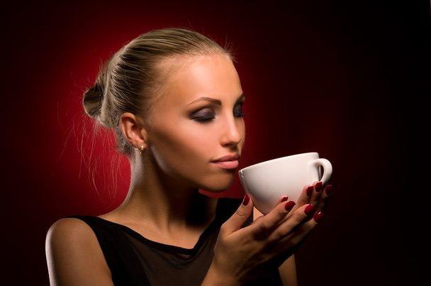 sexy girl with aggressive makeup and white cup - 写真・画像