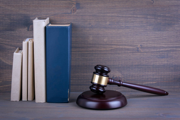 Wooden gavel and books in background. Law and justice concept - Photo, Image
