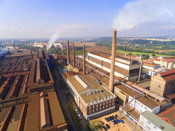 Aerial view of industrial zone with fuming chimneys.  Heavy industry from above. Steelworks in Pilsen, Czech Republic, European Union.  - Photo, Image