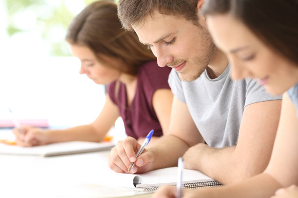 Close up of students taking notes at classroom - Photo, Image