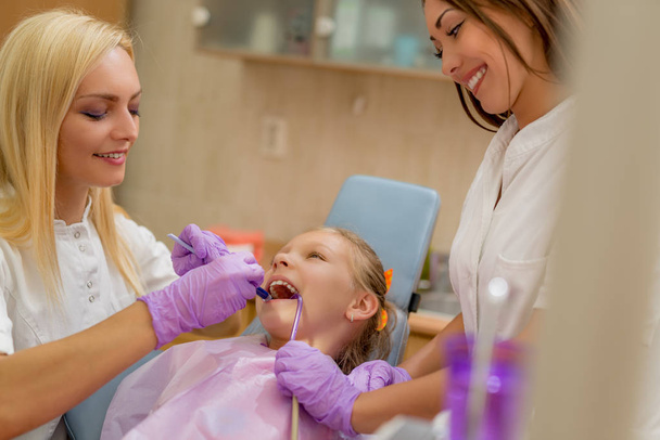 girl sitting on chair in dentist office - Photo, Image