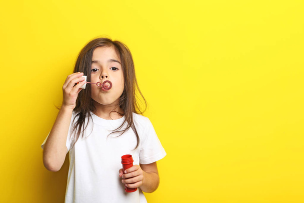 little girl blowing soap bubbles  - Фото, изображение