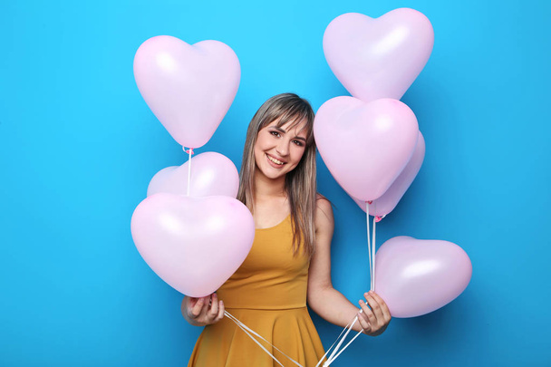Woman with pink heart balloons  - Фото, изображение