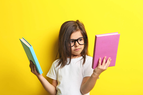 little girl with glasses and books - Valokuva, kuva