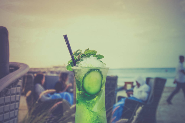Mojito in a glass on a background of a beach and blue sky with c - Fotografie, Obrázek