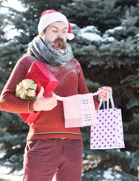 Surprised santa man opens presents - Foto, Imagen