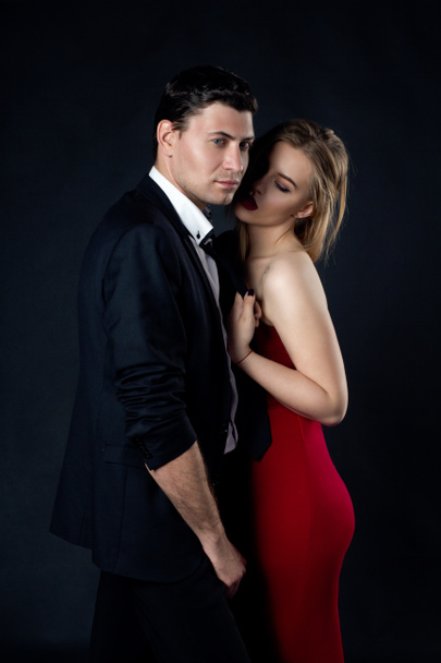 Young couple in evening gown in black background  - Fotografie, Obrázek