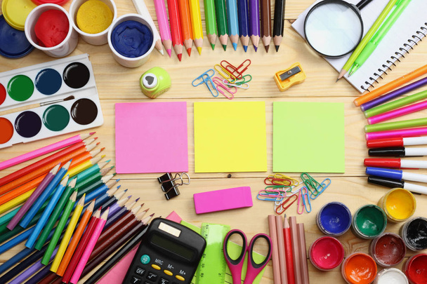 school and office supplies. school background. colored pencils, pen, pains, paper for  school and student education on wooden background. top view - Fotó, kép