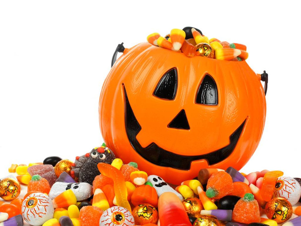 Halloween Jack o Lantern pail overflowing with candy - Photo, Image