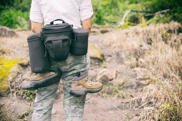 photographer hiking walking with backpack and camera in mountains, travel concept, hiking concept - 写真・画像