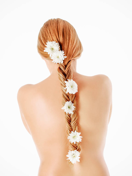 beautiful young girl with long hair with flowers in braid - Photo, Image