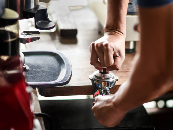 Coffee maker push the coffee powder in the espresso scoop - Фото, изображение