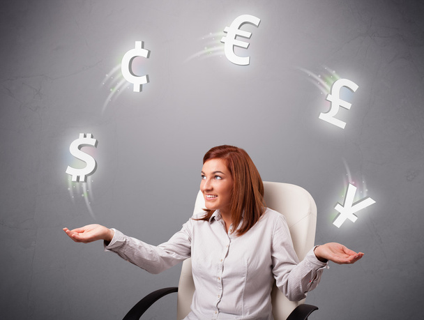 young lady sitting and juggling with currency icons - Foto, Bild