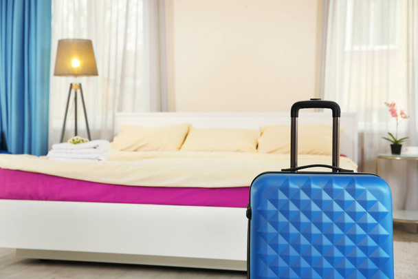 Blue suitcase in room - Φωτογραφία, εικόνα