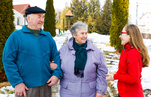 Elderly couple and young caregiver - Photo, Image