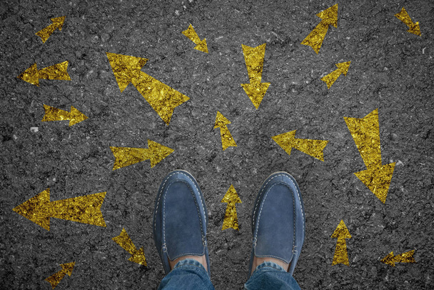 man standing on road with many direction arrow choices or move  - Photo, Image