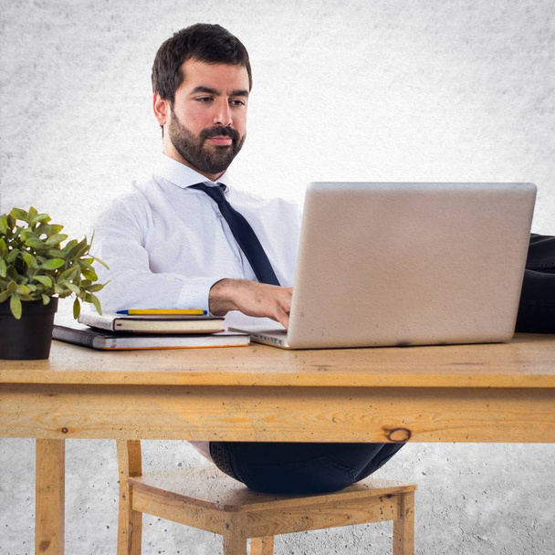 Businessman working with laptot in his office - Fotó, kép