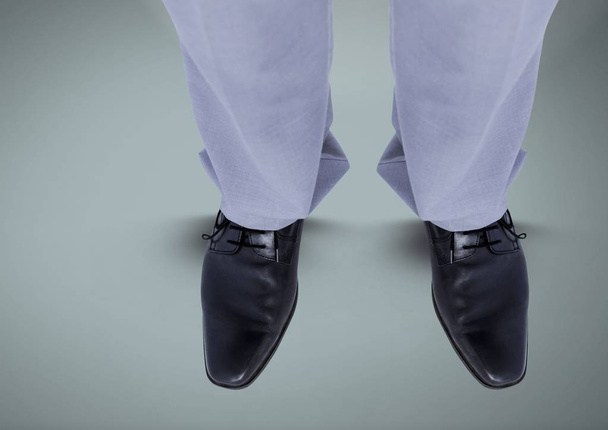 Businessman feet and shoes on blue background - Foto, afbeelding