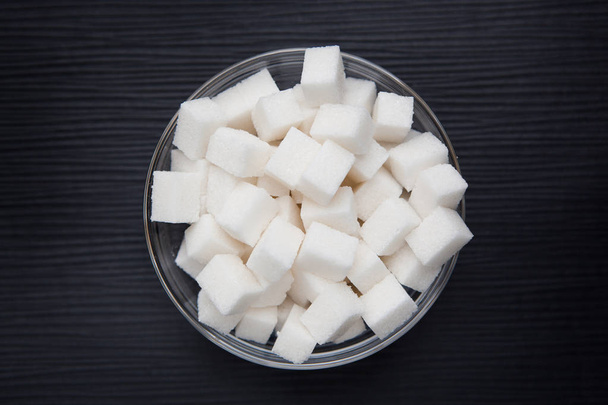 White sugar cubes on black background - Foto, Bild