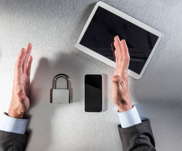 confident businessman hands protecting padlock at the office, above view - Φωτογραφία, εικόνα