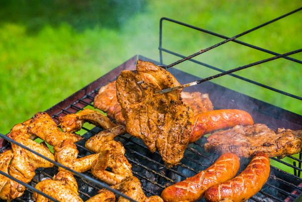 BBQ in the garden - selection of meat on flaming grill - Photo, Image
