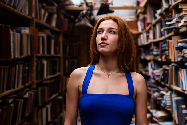 Portrait of ballerina girl in vintage book store wearing casual clothes - Фото, зображення