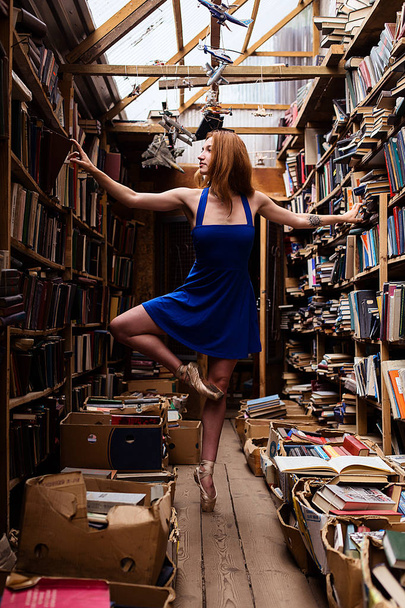 Portrait of ballerina girl in vintage book store wearing casual clothes - Zdjęcie, obraz