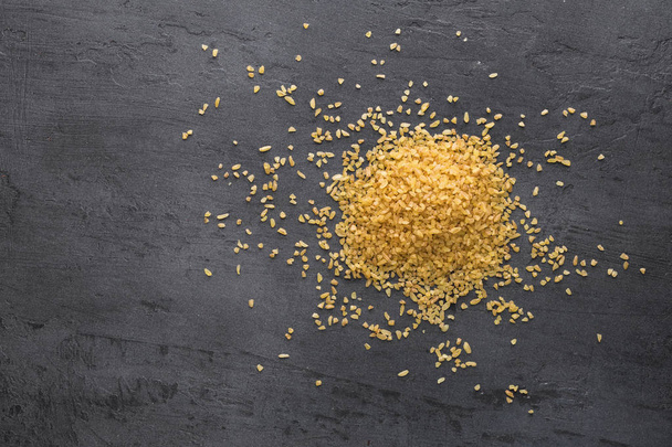 Seeds bulgur on dark background with copy space - Photo, image
