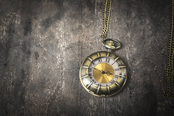 still life with pocket watch on grunge wooden table : vintage style - Photo, Image