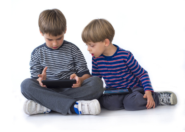 Two brothers playing games on the tablets - Photo, Image