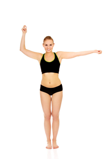 Athletic young woman doing arm exercises - Fotó, kép