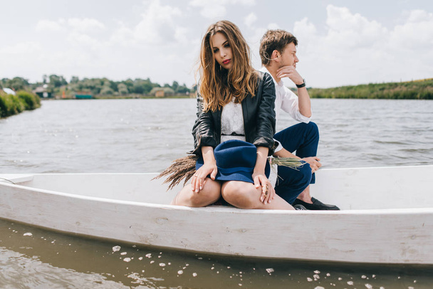 Lovely couple in boat on lake - Фото, изображение