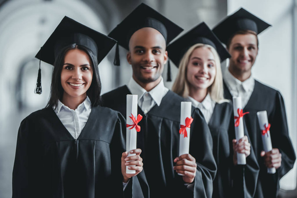 Graduates in university - Фото, изображение