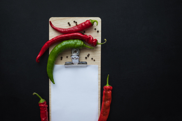 peppers and blank paper sheet - Фото, изображение