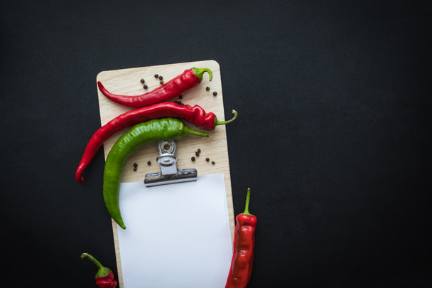 peppers and blank paper sheet - 写真・画像