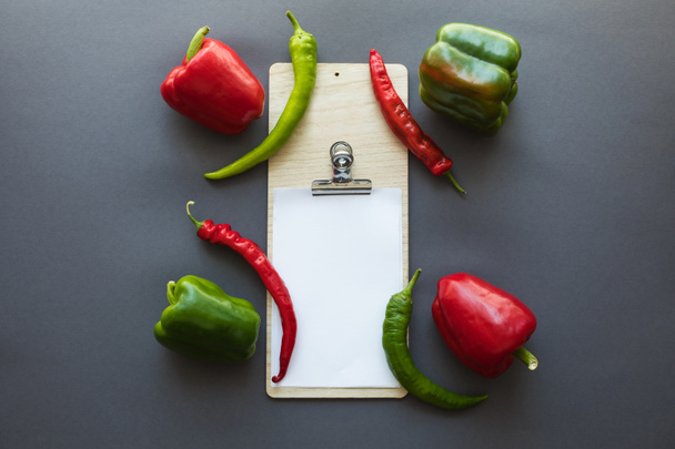 peppers and blank paper sheet - Fotó, kép