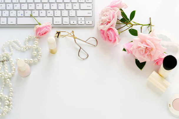 Flat lay, top view office feminine desk, female make up accessories, workspace with laptop and bouquet roses.Beauty blog concept.Copy space - Φωτογραφία, εικόνα