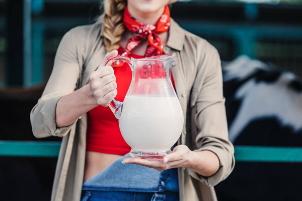 farmer with milk in glass jug - 写真・画像